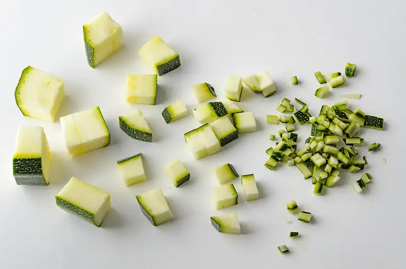 Different sizes of diced zucchini