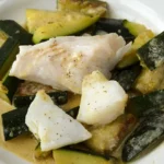 Recipe or fish steamed over a bed of zucchinis